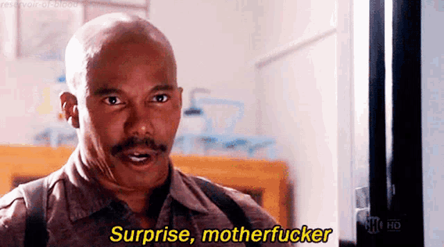 a bald man with a mustache is saying surprise motherfucker .