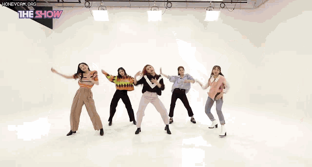 a group of women are dancing in front of a white background with the show written on the bottom
