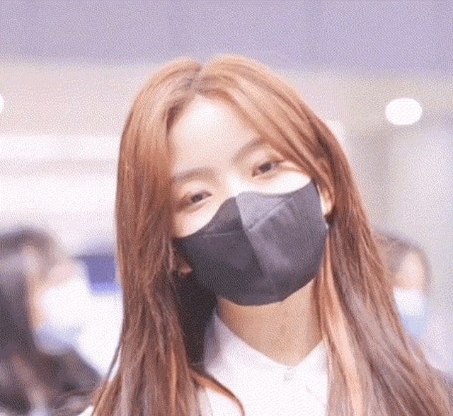 a close up of a woman wearing a mask on her face .