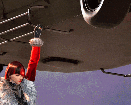 a woman with red hair and a fur coat is reaching for something in the ceiling