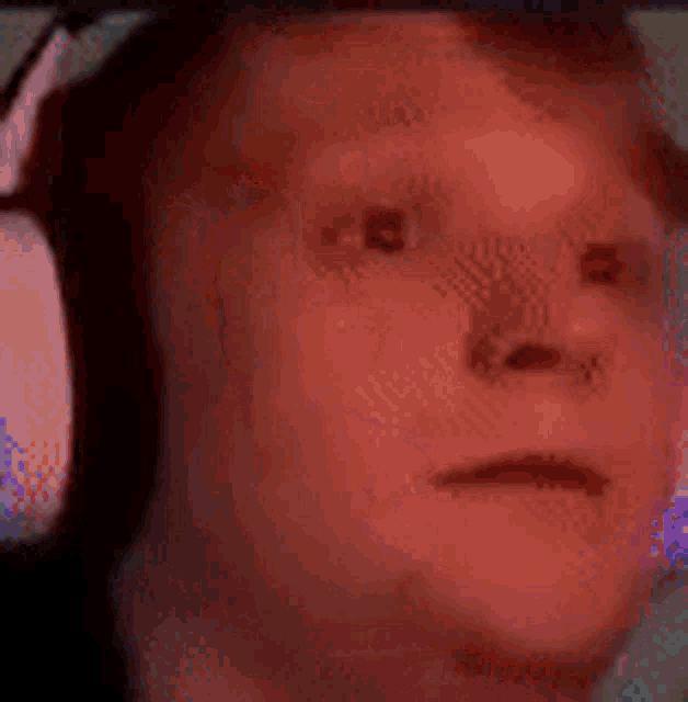 a man wearing headphones is making a funny face .