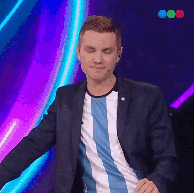 a man wearing a striped shirt and a suit is dancing