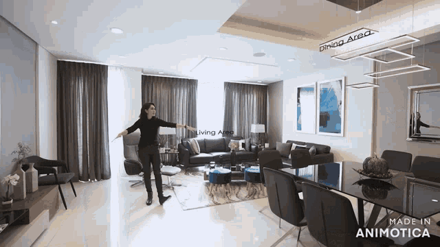 a woman is standing in a living room with a sign that says dining area on it