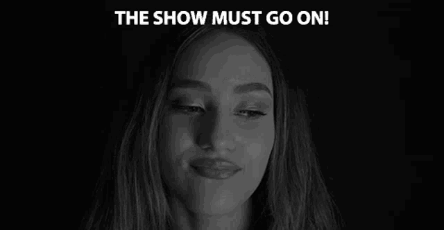 a woman is smiling in a black and white photo with the words `` the show must go on '' written above her .