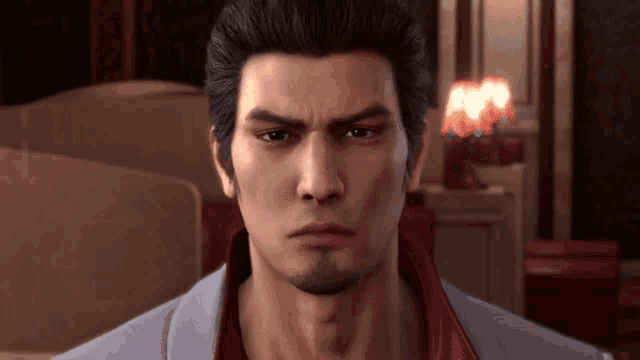 a close up of a man 's face with a red shirt on