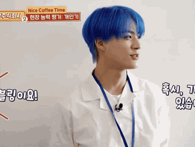 a man with blue hair is wearing a lanyard and a white shirt