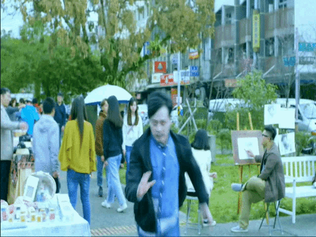 a man in a blue shirt is running in a crowded street