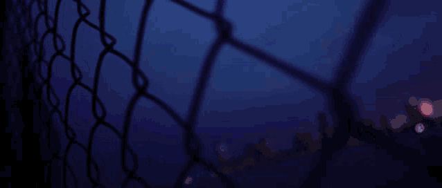 a blurry picture of a chain link fence with a glitch effect that says npo