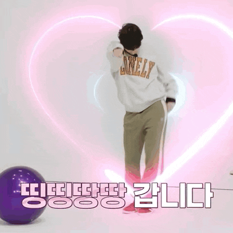 a man wearing a sweatshirt that says lonely is standing in front of a purple ball .