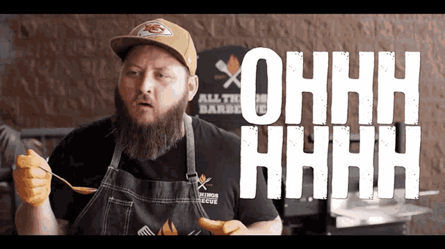 a man holding a spoon in front of a sign that says ohhh