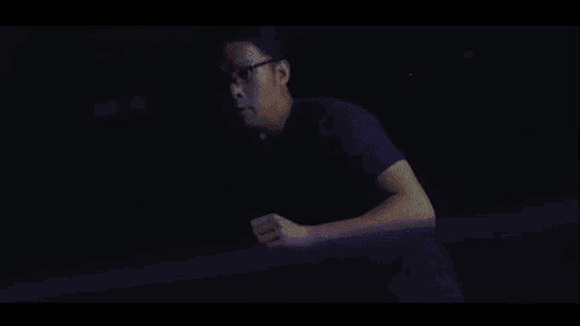 a man in a blue shirt with flames coming out of his head