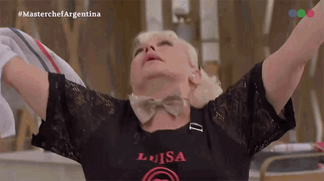 a woman in a black shirt that says luisa
