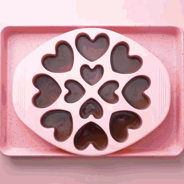 a pink tray with hearts on it that says mr. baker on the bottom