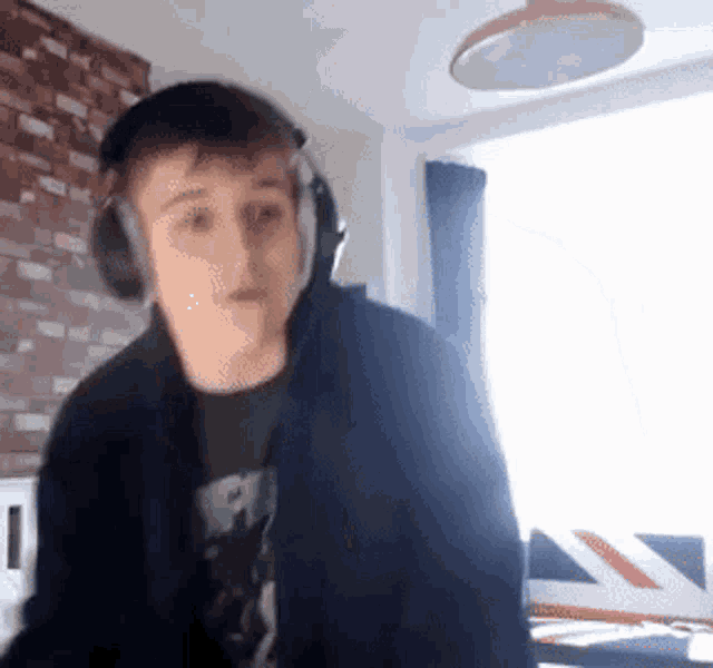 a young man wearing headphones is standing in a room