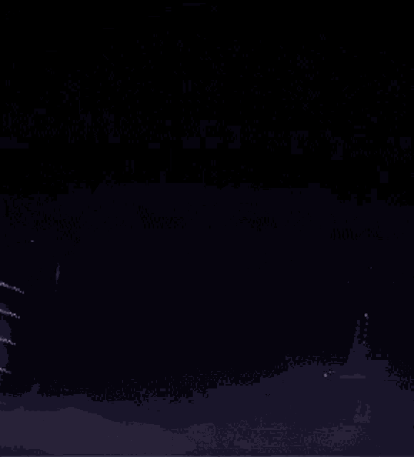 a person in a dark room with a purple cape