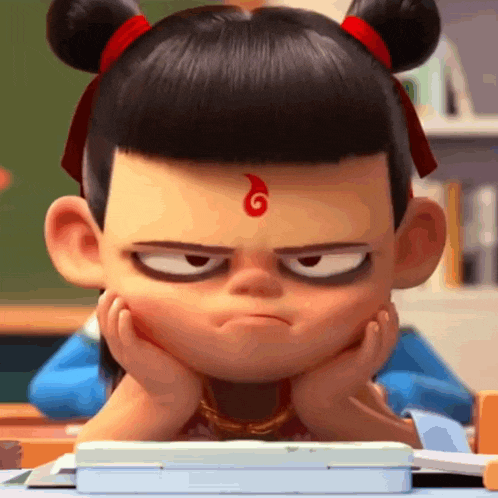 a cartoon character with a red flame on his forehead is sitting at a desk with his hands on his chin