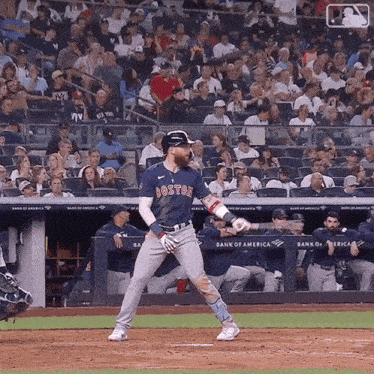 a boston baseball player getting ready to swing at a ball