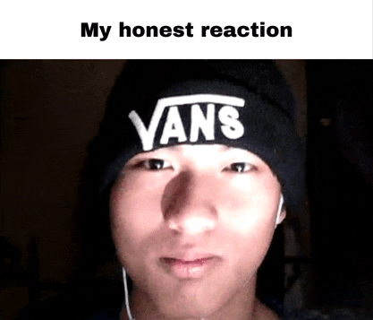 a young man wearing a black vans beanie looks at the camera