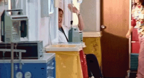 a man is sitting in a hospital room holding an iv .
