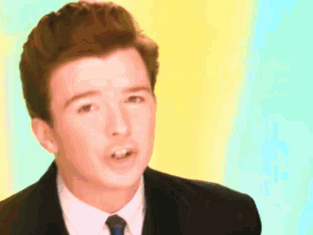 a man in a suit and tie is making a funny face .