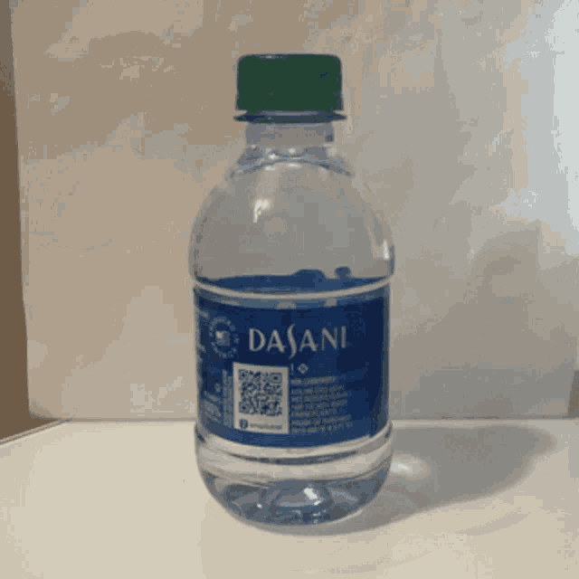 a bottle of dasani water is sitting on a table