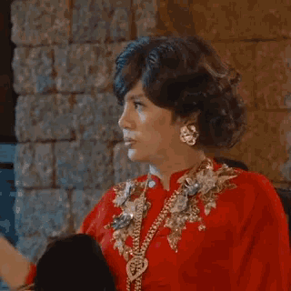 a woman in a red dress with the word suyt in red letters