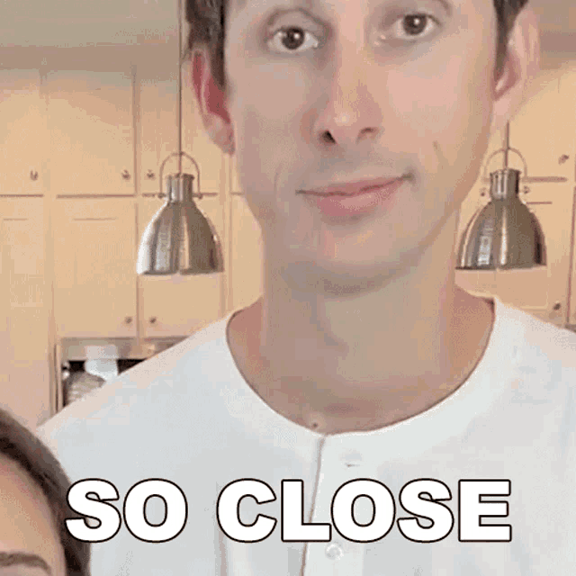 a man in a white shirt says so close in front of a woman 's face .