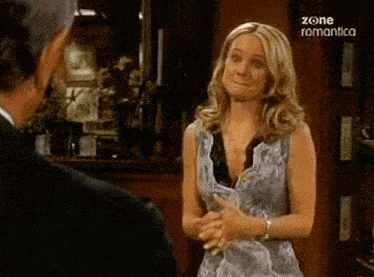 a woman is talking to a man with the words zone romantica on the bottom