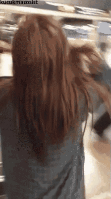 a woman with long red hair is standing in front of a table with the words kucukmazosist written on the bottom