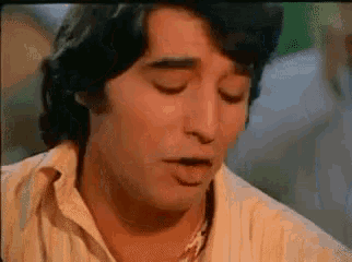 a close up of a man 's face with his eyes closed in a movie .