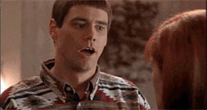 a man in a shirt is talking to a woman in a room .