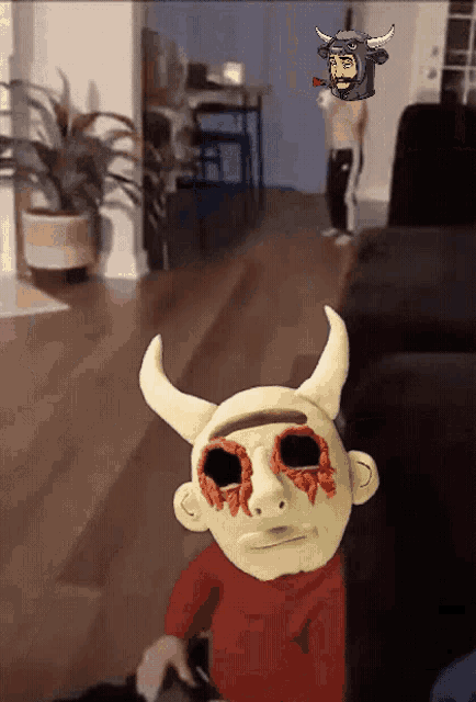 a person wearing a devil mask with horns