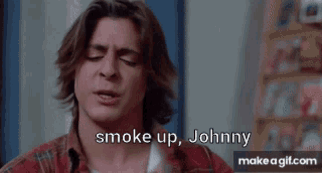 a man in a plaid shirt is screaming and saying smoke up johnny .