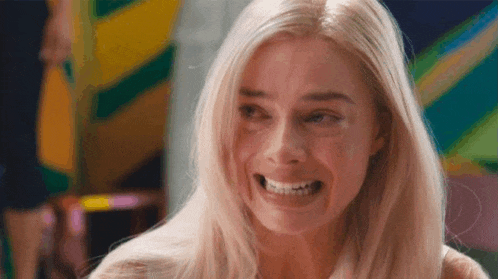a close up of a woman making a funny face and smiling .
