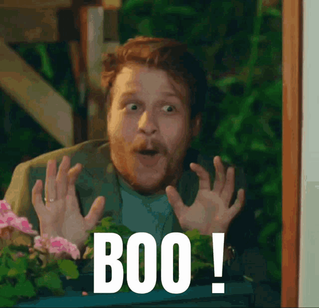 a man with a surprised look on his face and the word boo on the bottom right