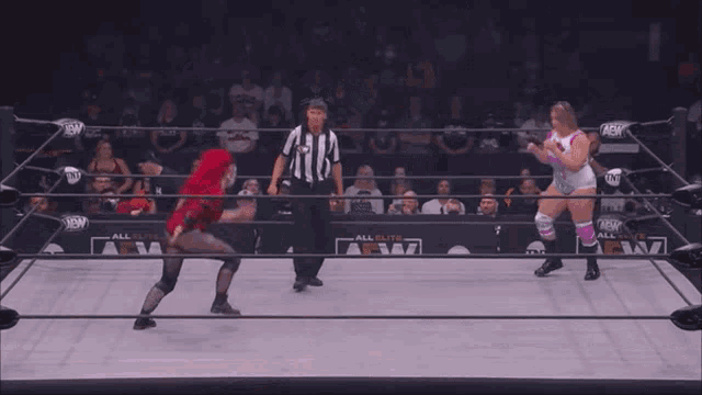 a woman in a purple knee brace is fighting another woman in a wrestling ring .