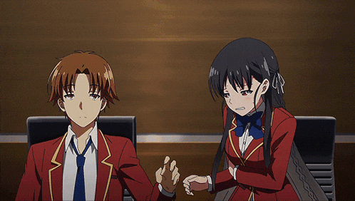 a man in a red suit stands next to a woman in a white skirt