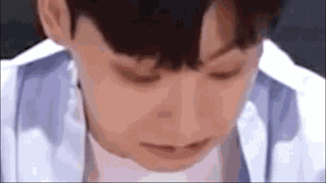 a close up of a person 's face with their eyes closed and their mouth open .
