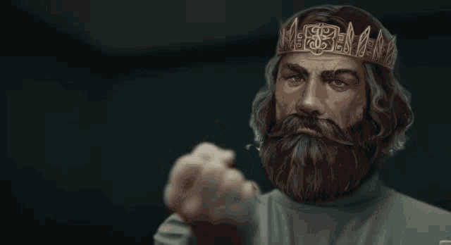 a man with a beard and a crown giving a thumbs up