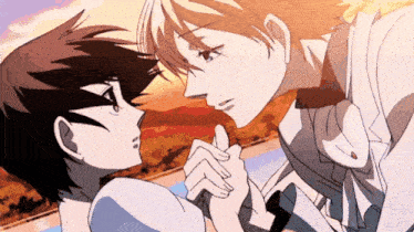a man and a woman are holding hands and looking at each other