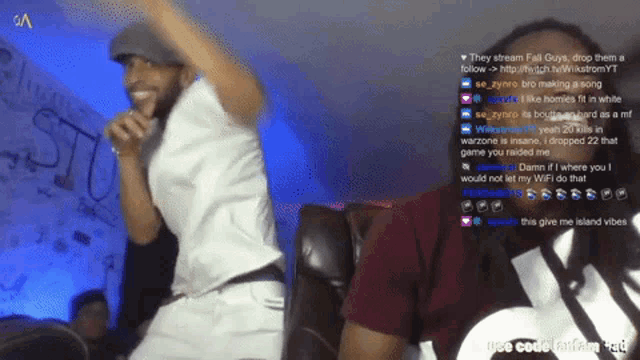 a man singing into a microphone with the words " they stream fall guys " on the bottom right