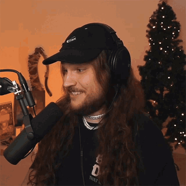 a man wearing headphones and a hat that says that 's on it