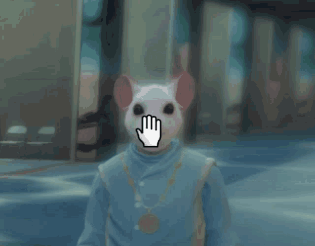 a person wearing a mouse mask with a hand pointing to it