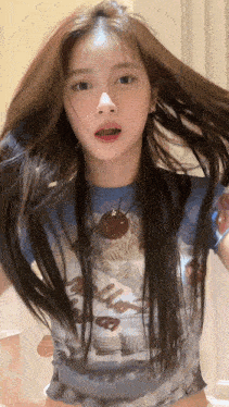 a girl with long hair wearing a shirt that says hello on it