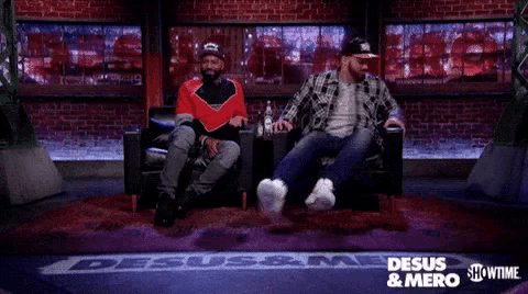 a man kneeling down in front of a sign that says " desus & mero "