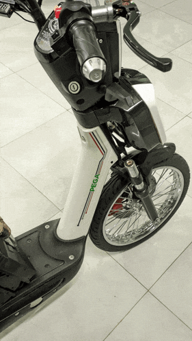 a pega scooter is sitting on a tile floor