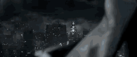 a person holding a wand over a city skyline