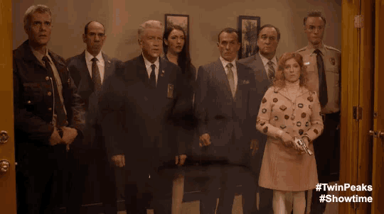 a group of people standing in front of a door with #twinpeaks #showtime on the bottom