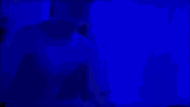 a man is standing in a dark room with blue lights .