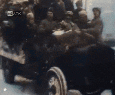 a group of people are riding in a vehicle with the letters 24 aok on the bottom